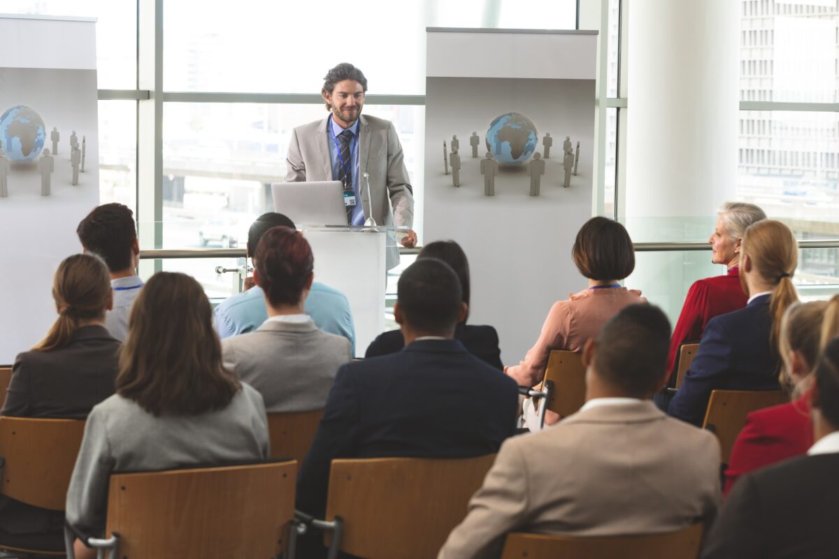 Businessman with laptop speaks at business seminar